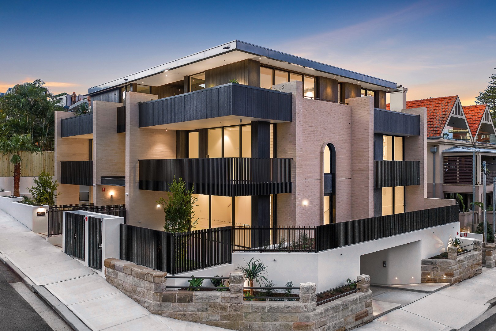 The Henry Manly exterior view — luxury boutique residence at dusk